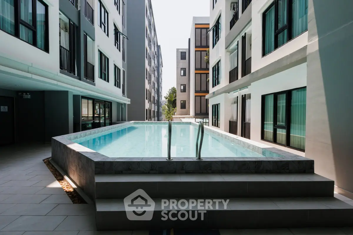 Modern apartment complex with sleek pool and contemporary architecture