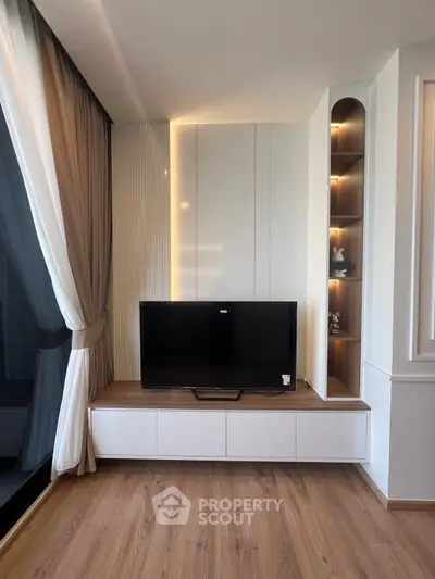 Modern living room with sleek TV unit and elegant curtains