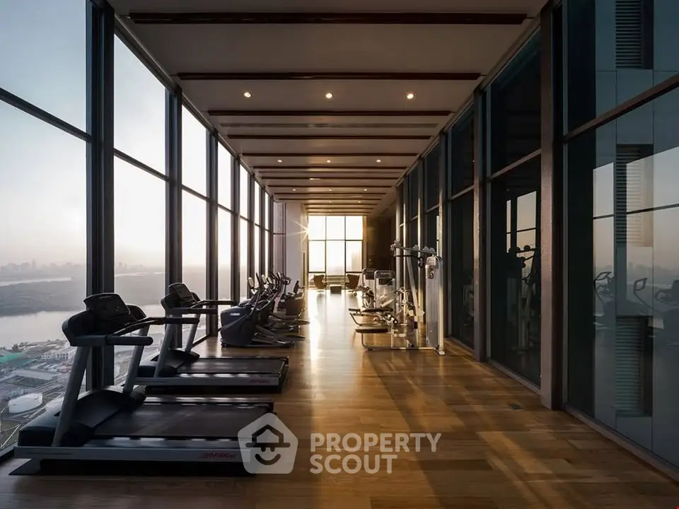 Luxurious high-rise gym with panoramic city views and modern fitness equipment.
