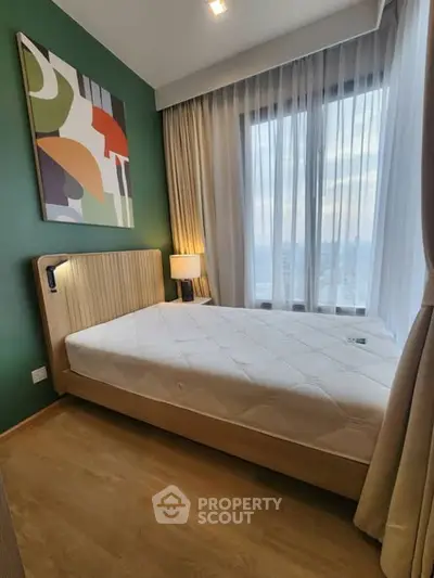 Modern bedroom with large window and stylish decor in a high-rise apartment.