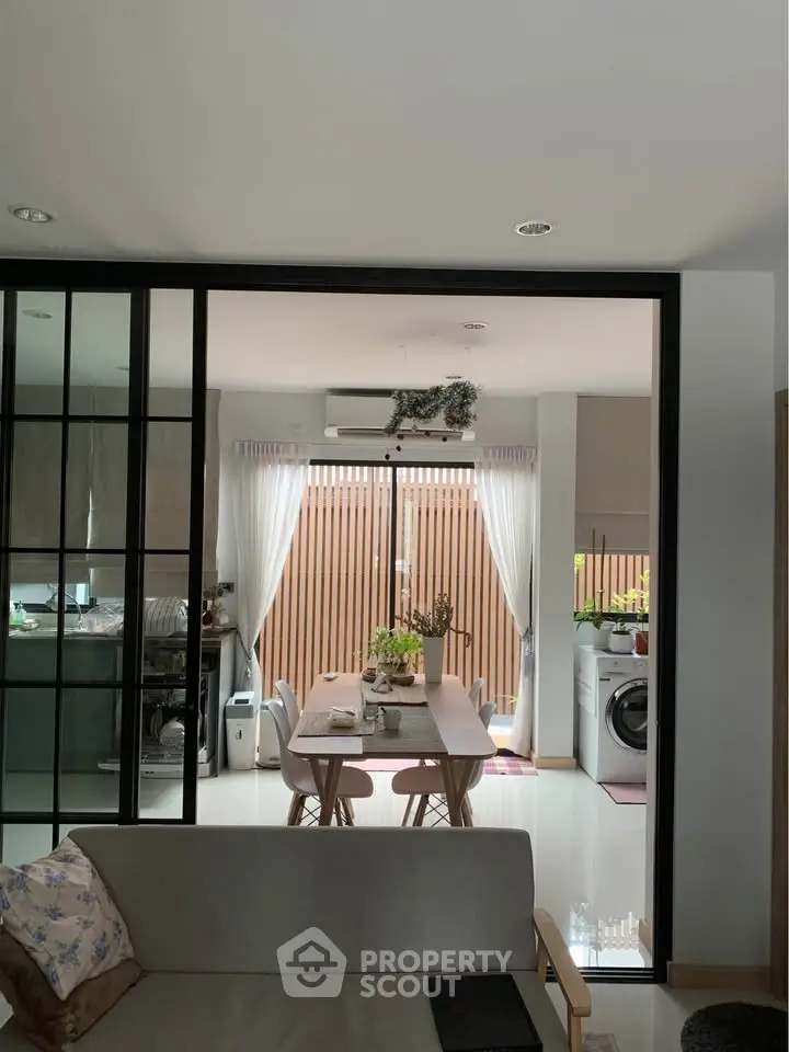 Modern open-plan living and dining area with natural light and stylish decor.