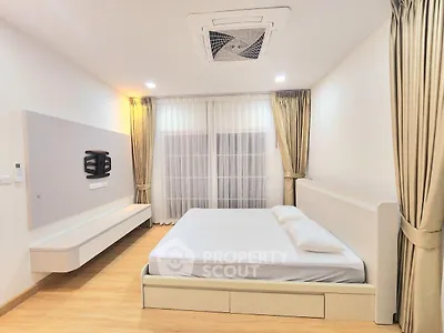 Spacious modern bedroom with elegant curtains and minimalist design