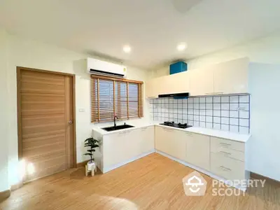 Modern kitchen with sleek cabinetry and gas stove in bright interior