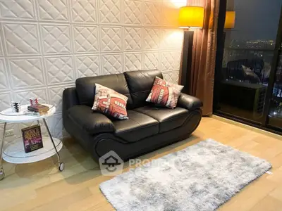 Stylish living room with leather sofa, cozy rug, and city view from large window.