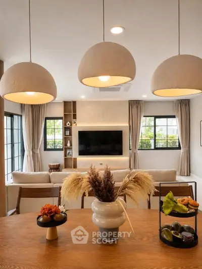 Elegant living room with modern lighting, cozy seating, and stylish decor, perfect for relaxation and entertainment.