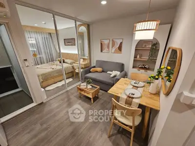 Cozy modern living room with dining area and view into bedroom