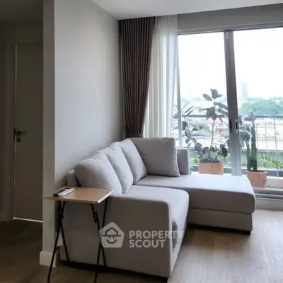 Cozy living room with modern sofa and balcony view