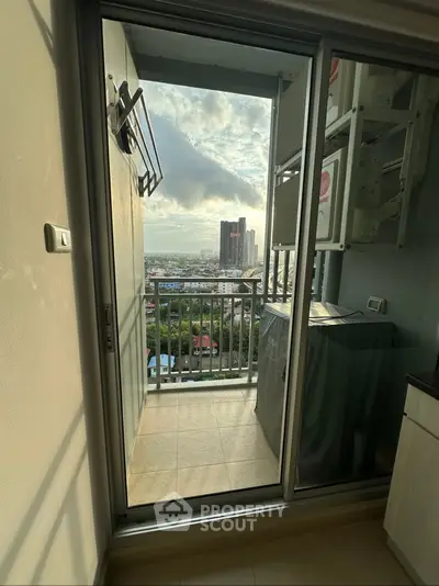 Stunning balcony view from high-rise apartment with cityscape and sunset.