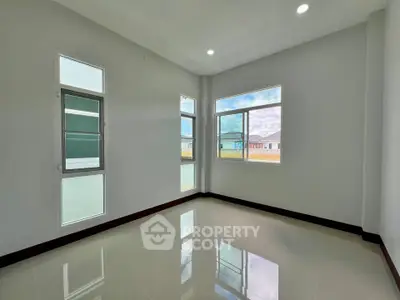 Bright empty room with large windows and glossy floor tiles