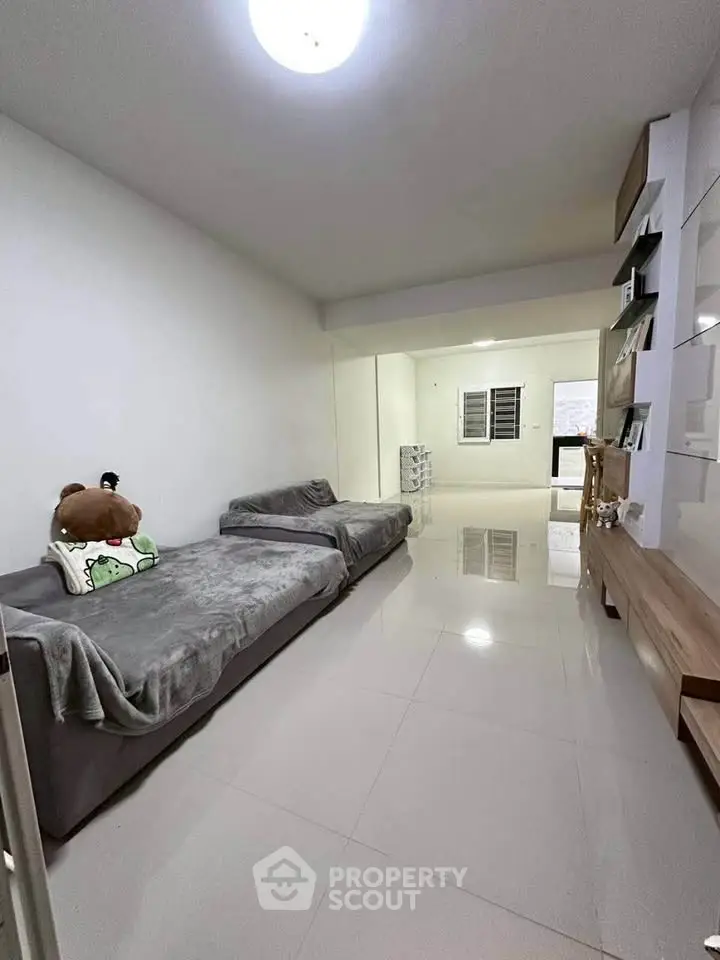 Spacious living room with modern minimalist design and cozy seating area.