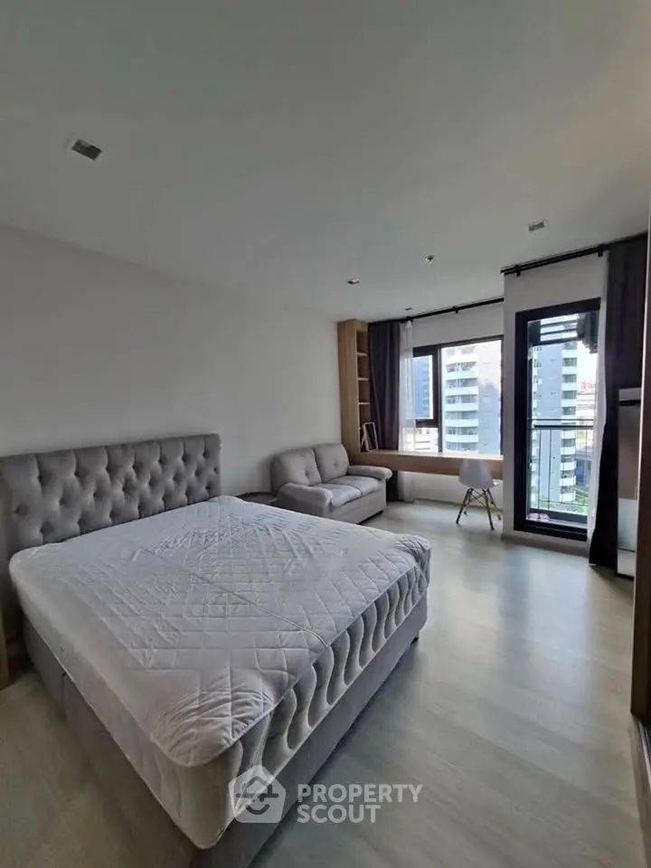 Spacious modern bedroom with city view and elegant furnishings