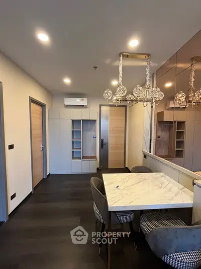 Modern dining area with elegant lighting and marble table