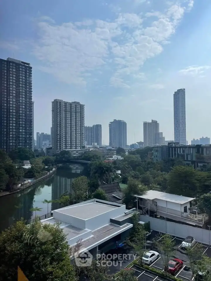 Stunning cityscape view with modern high-rise buildings and serene river, perfect for urban living enthusiasts.