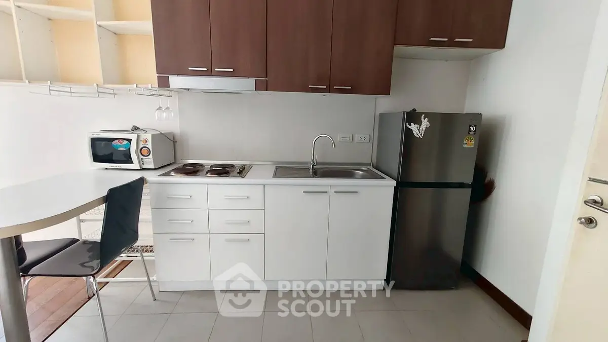 Modern compact kitchen with sleek cabinets and stainless steel appliances