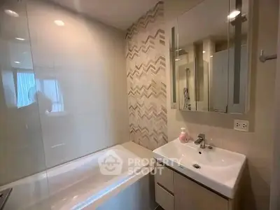 Modern bathroom with bathtub and stylish tile design