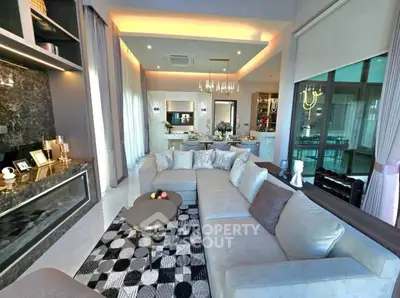 Luxurious living room with modern decor and open kitchen layout