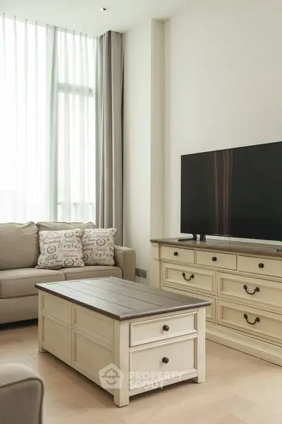 Charming living room with elegant furniture and natural light, perfect for relaxation and entertainment.