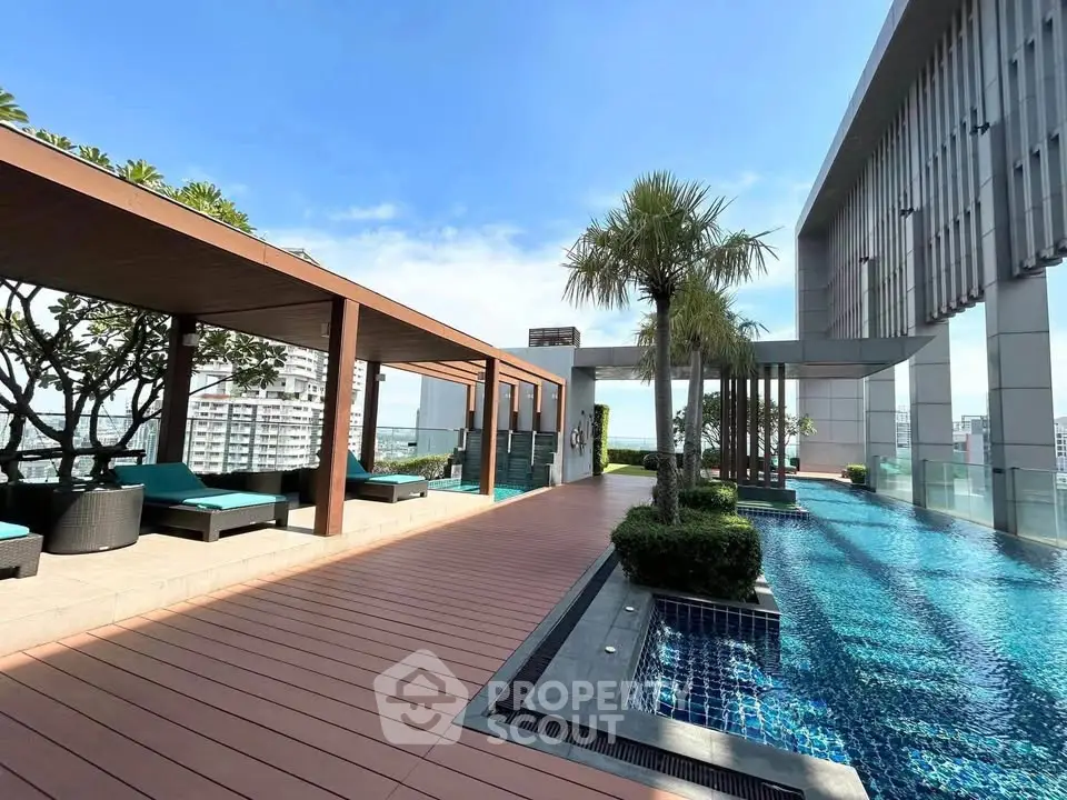 Luxurious rooftop pool with stunning city views and modern lounging area.