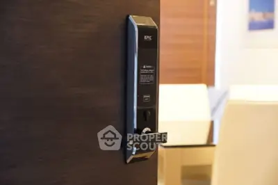 Modern digital door lock on a sleek wooden door in a stylish interior setting.