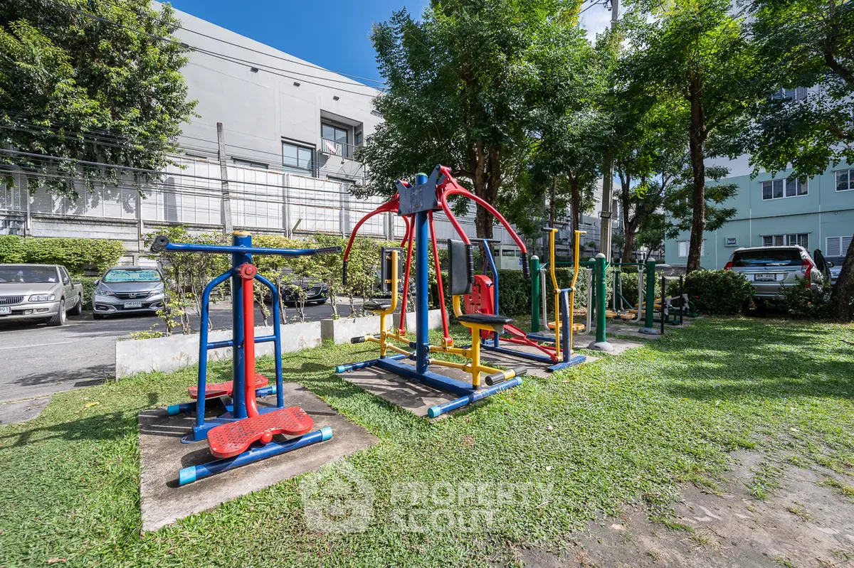 Outdoor gym area with colorful exercise equipment in a residential complex