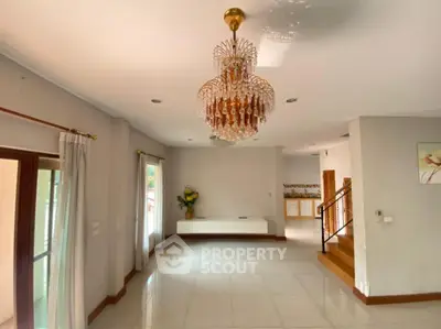 Spacious living room with elegant chandelier and modern decor