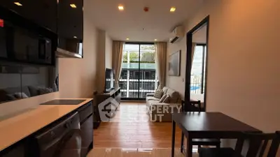 Modern living room with open kitchen and balcony view in stylish apartment
