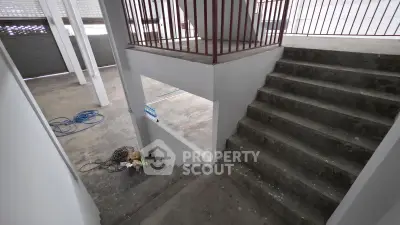 Industrial-style stairwell with concrete steps and open layout, ideal for creative workspace or loft conversion.