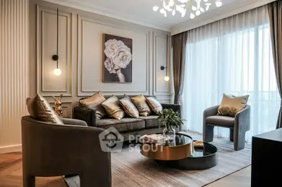 Luxurious living room with elegant decor and plush seating, featuring a chic chandelier and large window.