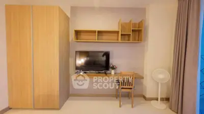 Modern study area with wooden furniture and TV setup