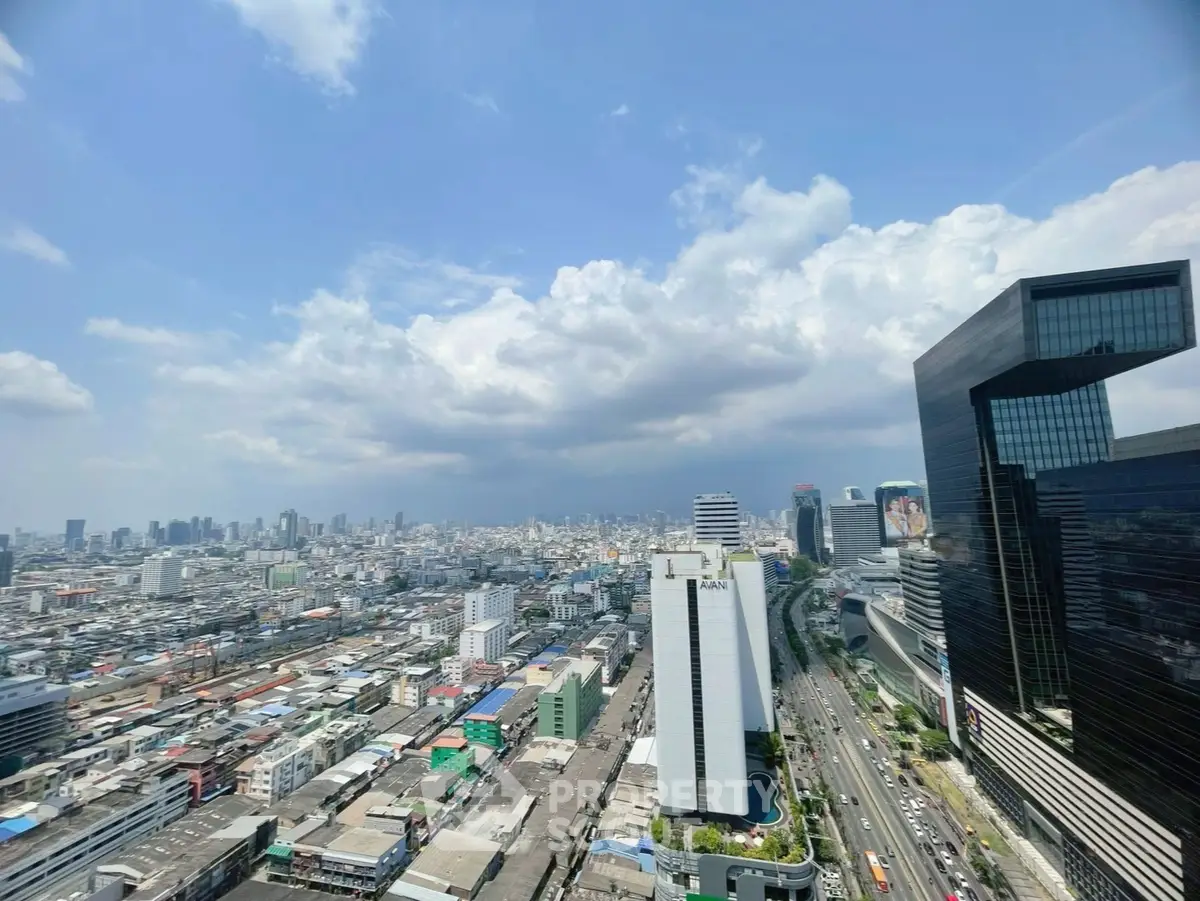 Stunning cityscape view showcasing modern skyscrapers and bustling urban life under a clear blue sky.