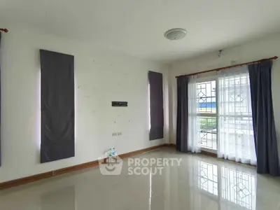 Spacious unfurnished room with large window and balcony access, perfect for customization.