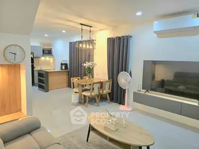 Modern open-concept living and dining area with stylish decor and contemporary kitchen.