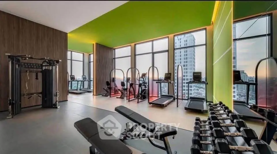 Luxurious high-rise gym with panoramic city views and modern fitness equipment.