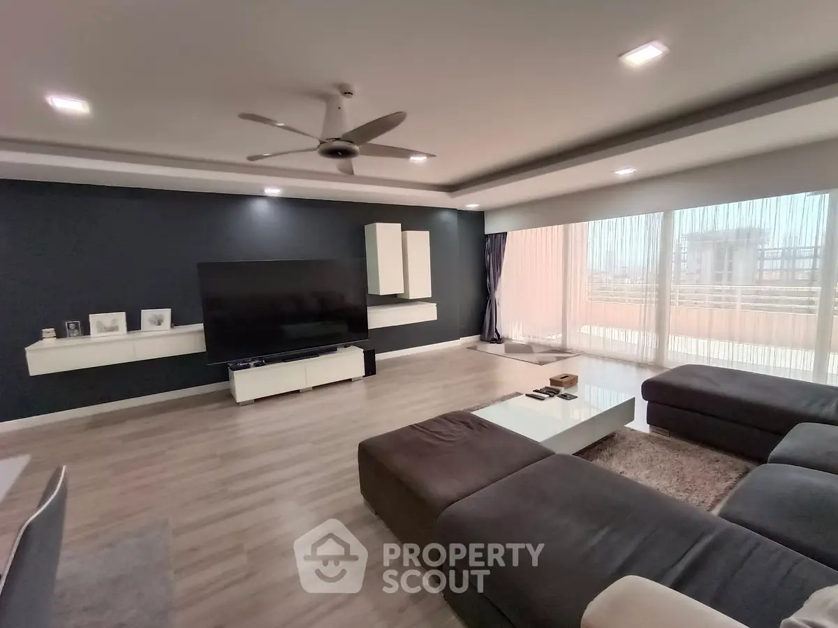 Spacious modern living room with large windows and sleek furniture