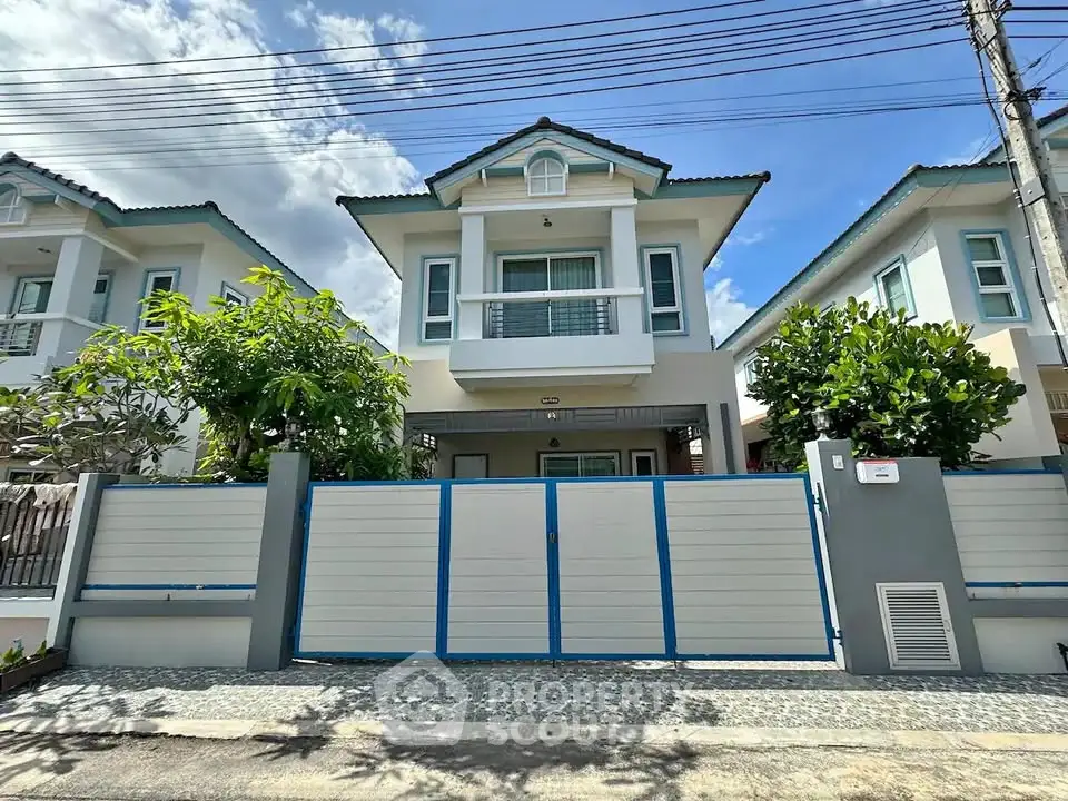 Charming two-story house with modern facade and lush greenery in a serene neighborhood.