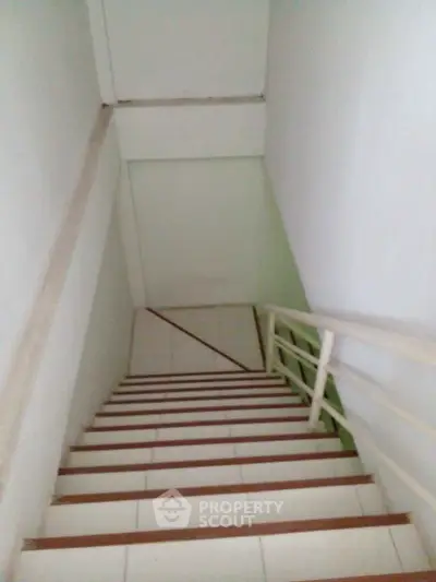 Minimalist staircase with white walls and railing, perfect for modern home design.