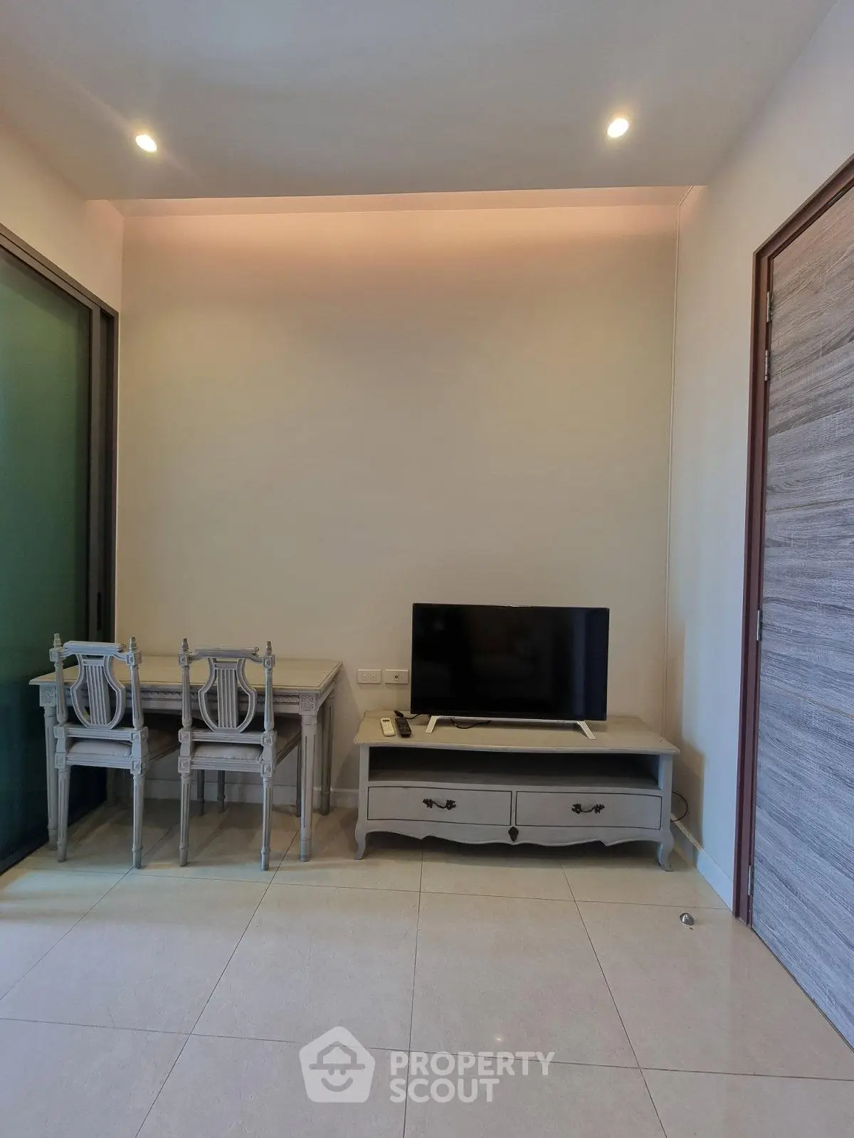 Modern living room with elegant furniture and flat-screen TV, perfect for cozy relaxation.