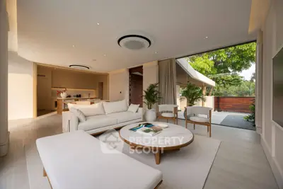 Luxurious open-plan living room with modern furniture and garden view