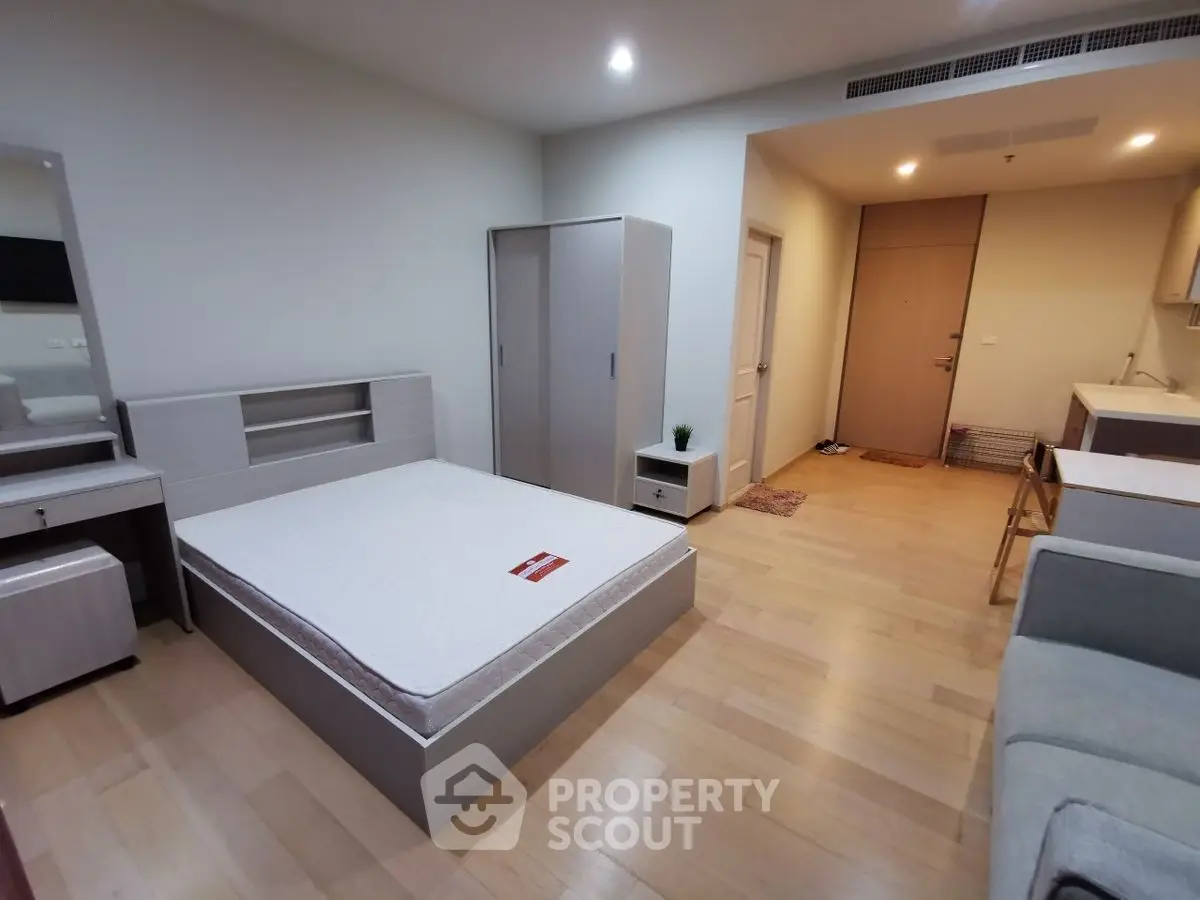 Spacious modern bedroom with minimalist furniture and wooden flooring