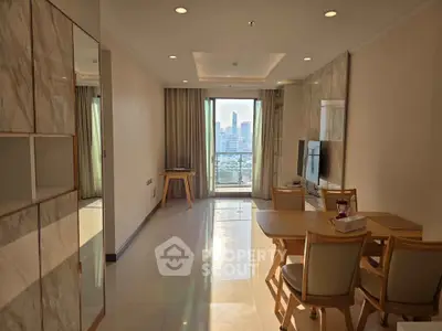 Spacious living room with city view, modern furniture, and natural light in a high-rise apartment.
