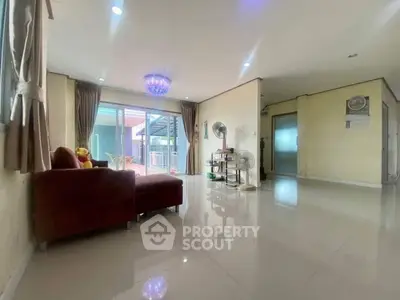Spacious living room with modern decor and large windows for natural light.