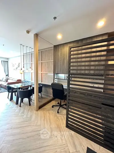 Modern open-plan living room with stylish dining area and study nook, featuring elegant wood finishes and ample natural light.