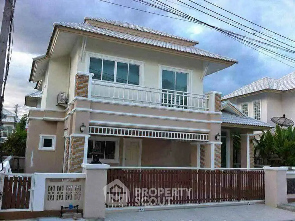Elegant two-story house with modern design and spacious balcony in a serene neighborhood.