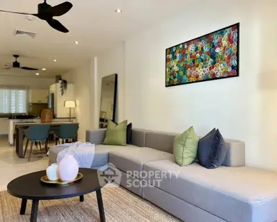 Modern living room with stylish decor and open layout leading to dining area.