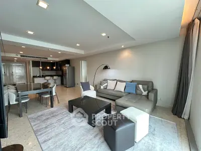 Spacious modern living room with open kitchen and stylish furniture in a luxury apartment.