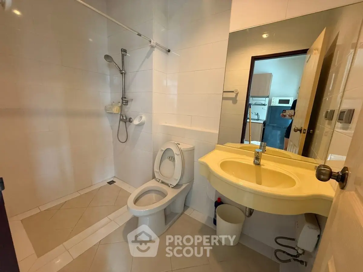 Spacious bathroom with modern fixtures and open shower design