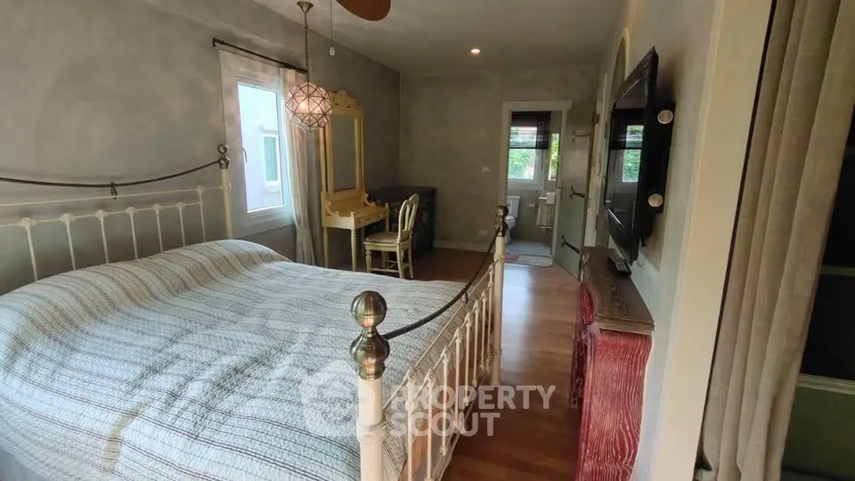 Charming bedroom with vintage decor and ample natural light