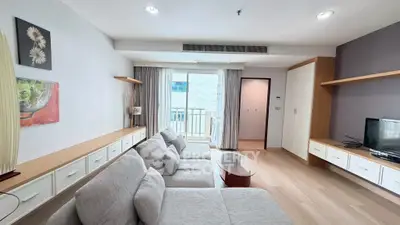 Spacious modern living room with cozy gray sofa and large windows for natural light.