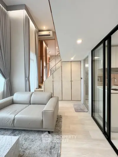 Modern duplex living room with sleek design and natural light