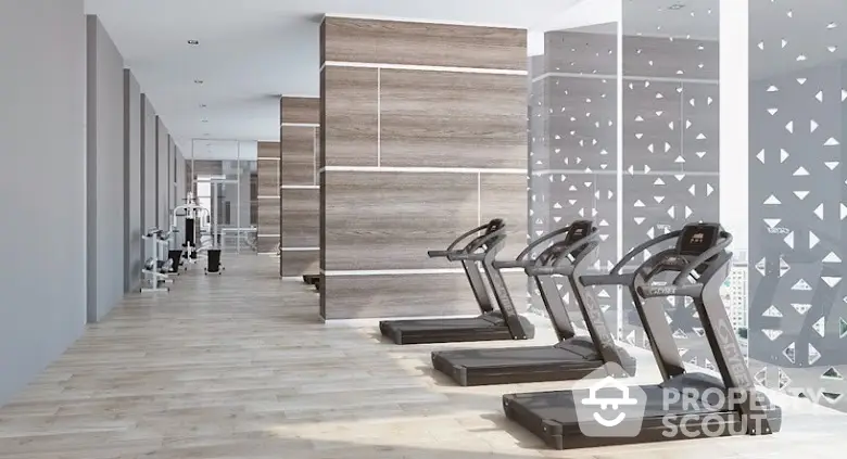 Modern gym with treadmills and stylish decor in luxury apartment building